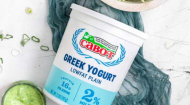 Closed container of Cabot Greek Yogurt laying on tabletop