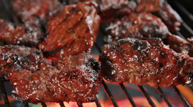 cooked beef meat chunks on a bbq grill