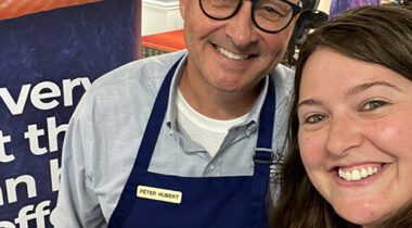 bald man and woman smiling at the camera