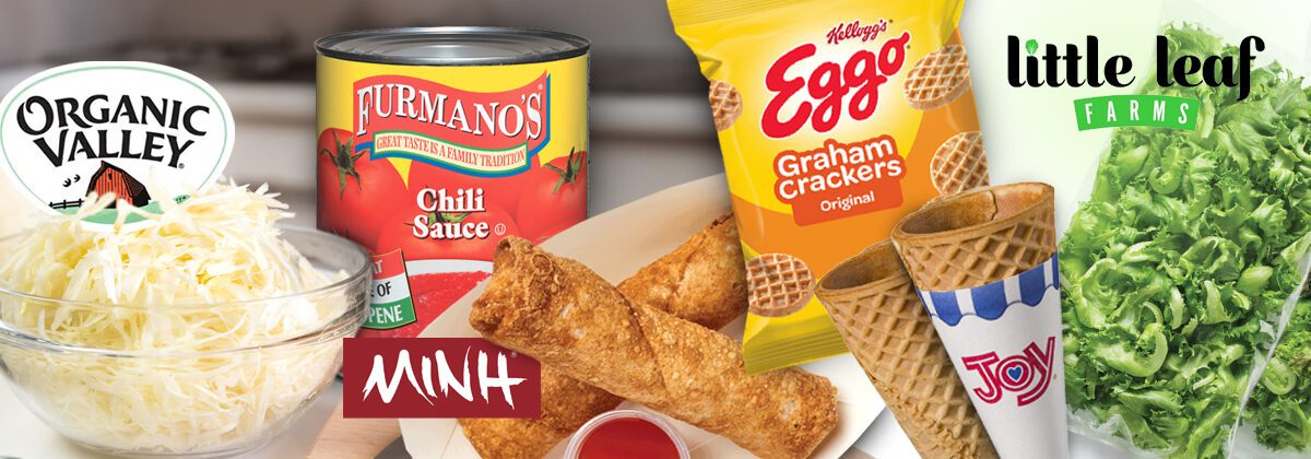 glass bowl of white shredded cheese next to #10 can of chili sauce next to to-go container with 2 egg rolls next to package of Eggo Graham Craker snacks next to two sugar cones next to two packages of lettuce