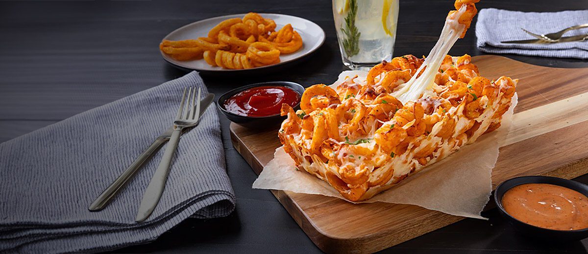spiral fries held together with melted cheese and shaped like a bread loaf