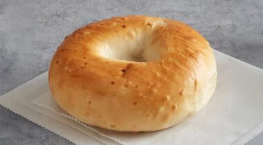 One onion bagel on napkin