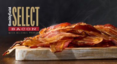 Smithfield Select Bacon logo over a pile of cooked bacon on cutting board