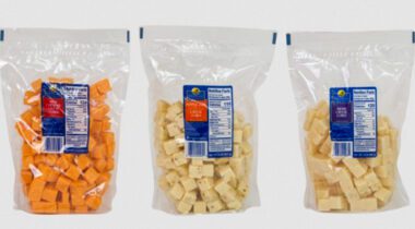 Three clear bags of cubed cheese