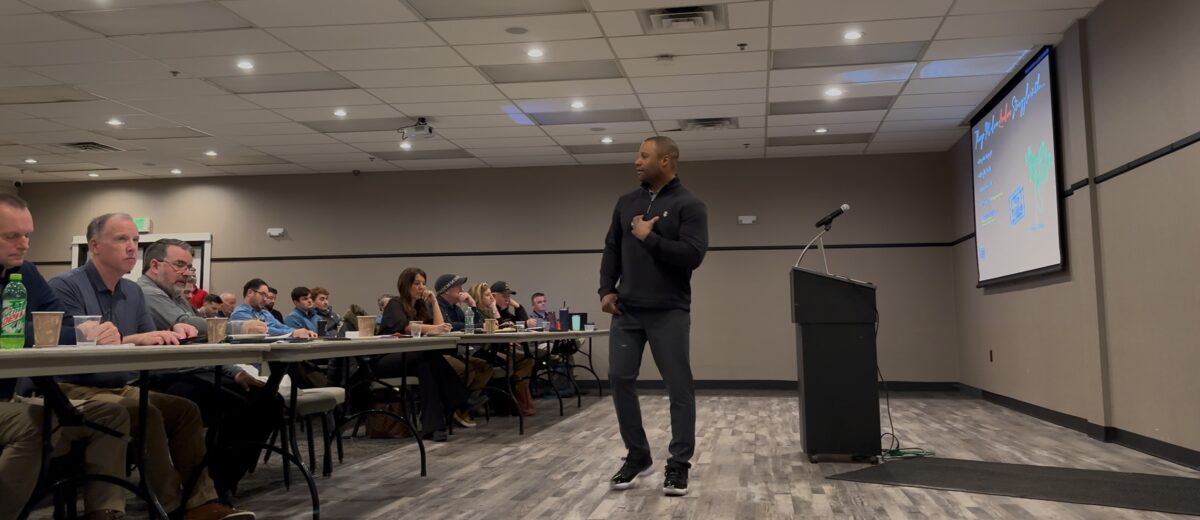 man speaking to audience in a meeting room