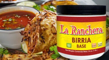Jar of La Ranchera Birria Base over image of prepared chicken tacos