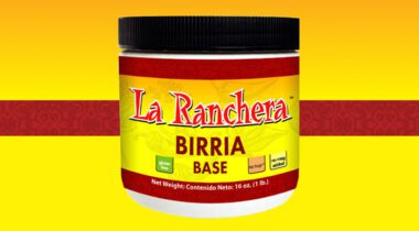jar or La Ranchera birria base, closed with a black lid, on a yellow background