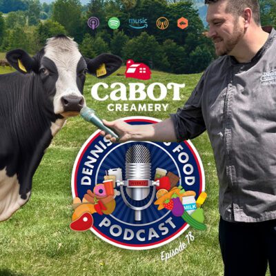 podcast logo in front of man holding microphone out to a cow in a farm field