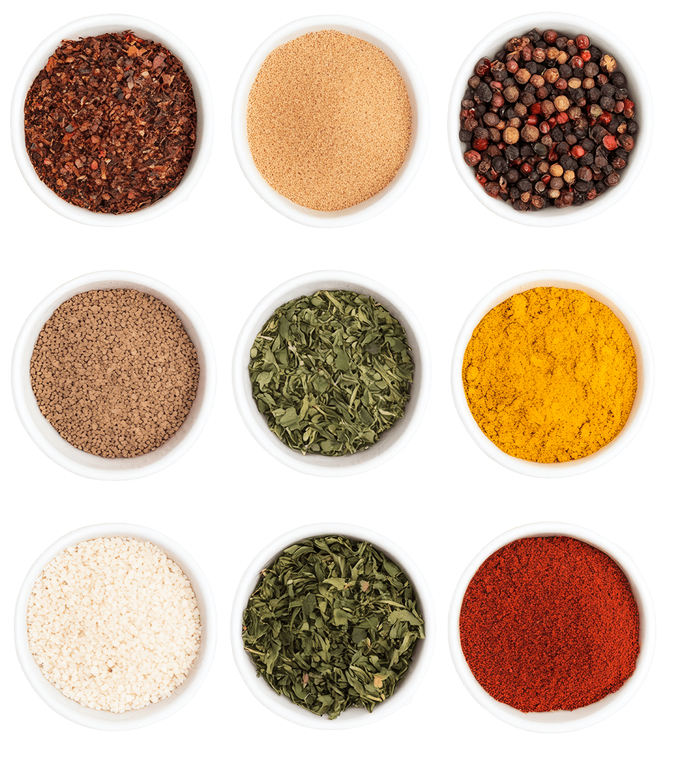 top view of 9 different color spices in small dishes