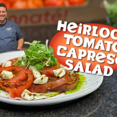 Heirloom Tomato Caprese Salad banner graphic with food, text, and chef
