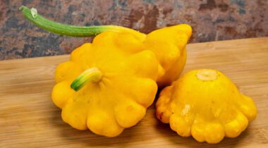 three patty pan squash on wood board