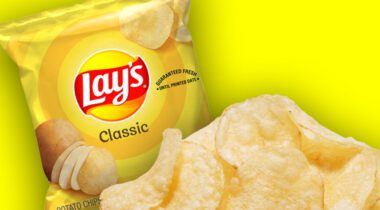 plain potato chips over bag of chips, on yellow background