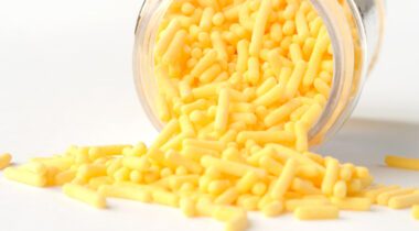 Tipped over jar of yellow jimmies