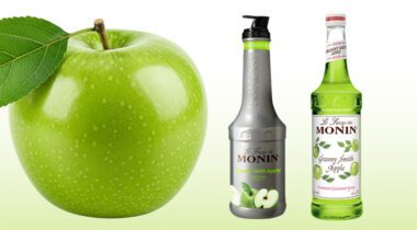Granny smith apple next to 2 bottles with granny smith artwork
