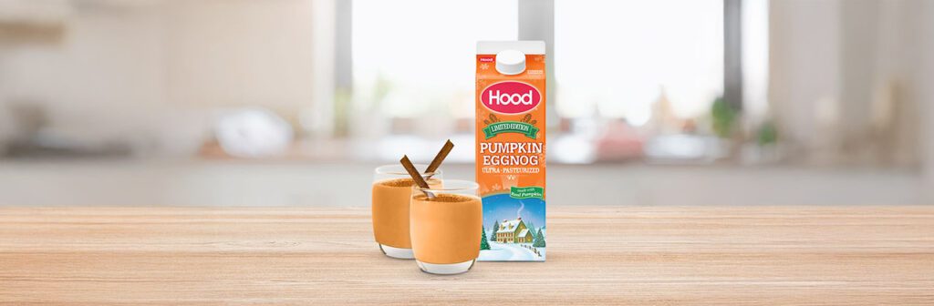 carton of eggnog next to 2 glass cups of eggnog