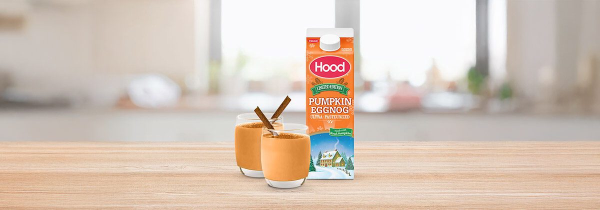 carton of eggnog next to 2 glass cups of eggnog