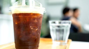 plastic cup of dark cold brew coffee with ice