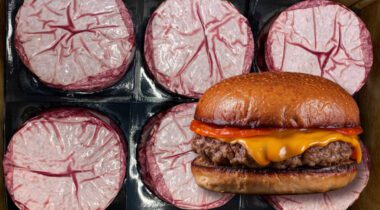 packaged raw burger patties behind a cheeseburger image