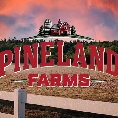 pineland farms logo over farm sunset field scene