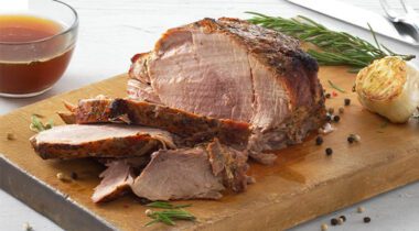 sliced cooked pork meat on a cutting board