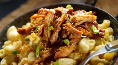 shredded bbq chicken on mac and cheese platter