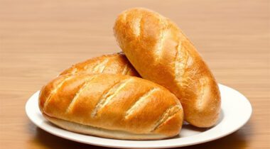 three white sub rolls on white plate