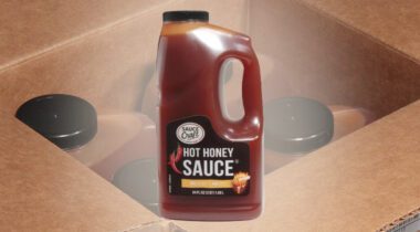 A 1/2 gallon jug of Sauce Craft brand hot honey sauce