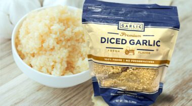 unopened bag of diced garlic over white bowl of fresh diced garlic