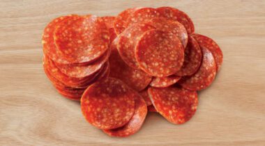 pepperoni slices on a wood cutting board