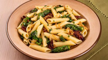 prepared bowl of penne pasta with veggie bits