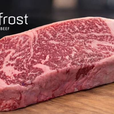 a well-marbled cut of steak on a cutting board