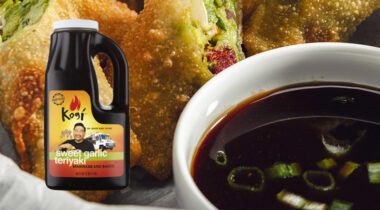 close up of soy dipping sauce on a plate with spring rolls, inset gallon jug of sauce