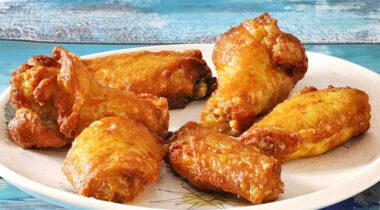 plate of six cooked chicken wings