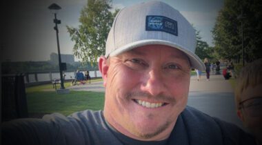 smiling white male wearing baseball cap