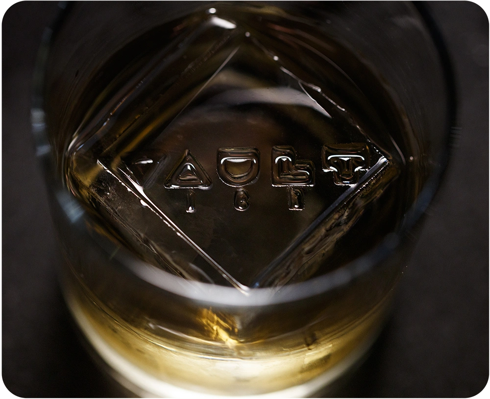 ice cube in a glass with VAULT ICE embossed in it