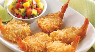 White Plate with 5 breaded butterfly shimp and bowl of colorful salad