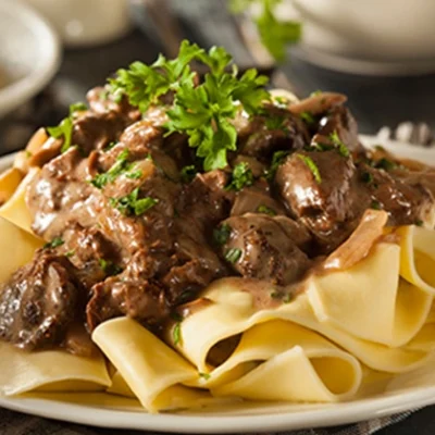 beef pot roast on a bed of noodles
