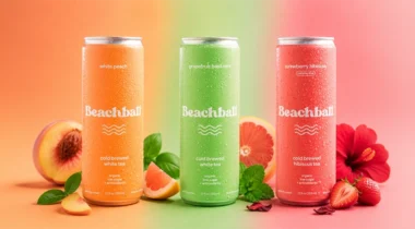 orange, green, pink beverage cans with fruits and floral elements