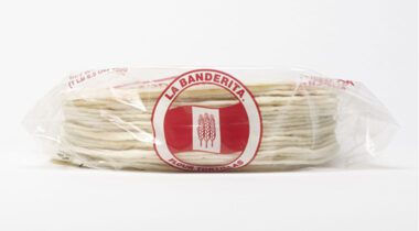 clear plastic package of flour warps, red logo, side view