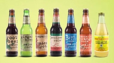 7 soda bottles / flavors over green background