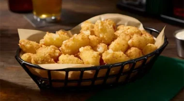 fried cheese curds in a black serving basket